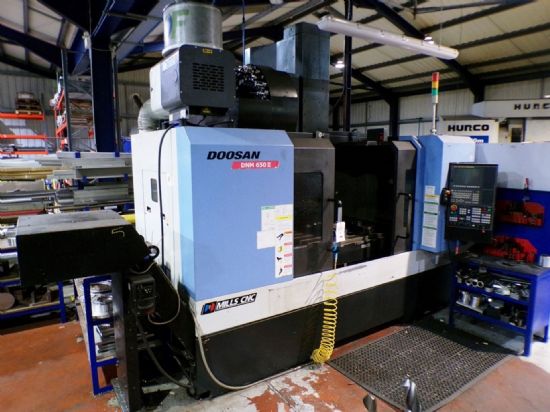 serial no. MV0011-001323 (2014), 
30 auto tool changer, 
table size 670 x 1300mm, 
2 machine vice
